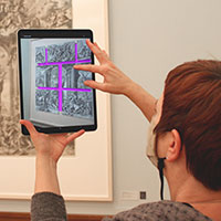 Person using the augmented reality app to look at art