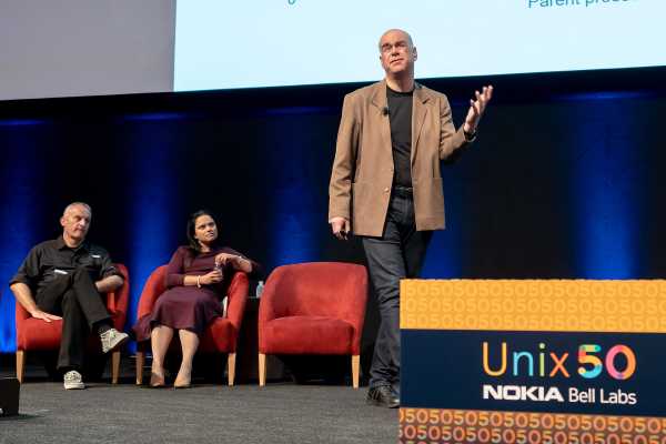 Markus Hofmann, Marina Thottan and Timothy Roscoe on stage at the Unix 50 event