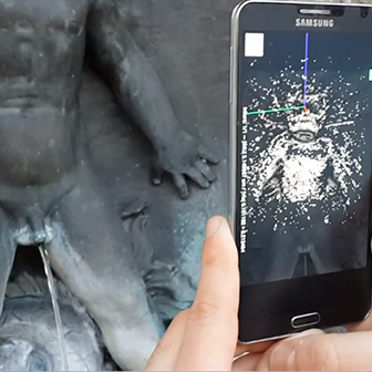 Person scanning a statue with a smartphone