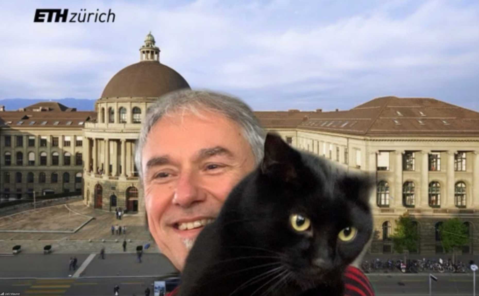 Zoom screenshot of Prof. Ueli Maurer holding a big black cat in front of an ETH Zurich background