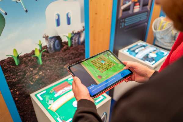hands holding a tablet displaying the Morph Tales game