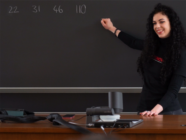 Natasha Savic explaining algorithms on the black board