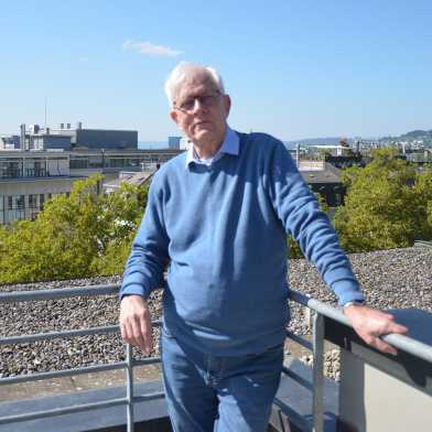 A professor with a blue sweater.