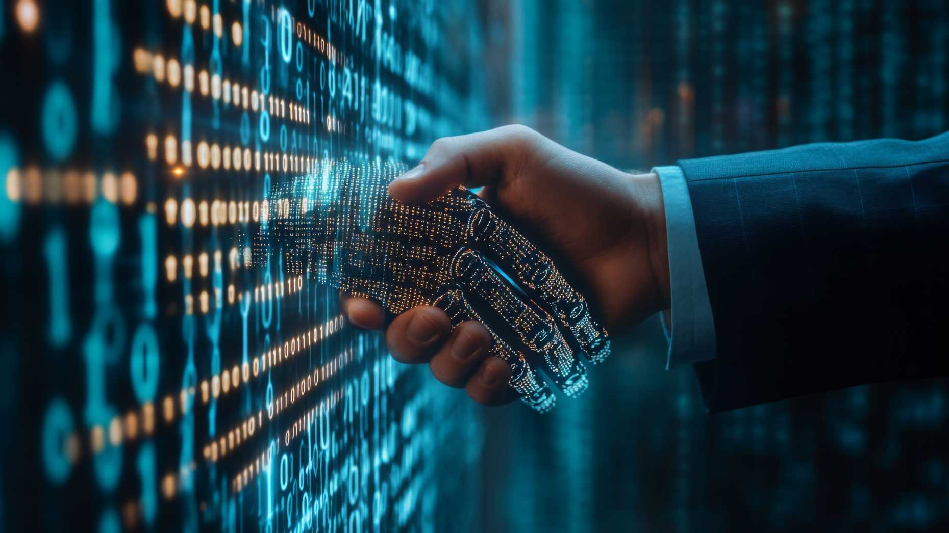 A human hand shakes a virtual hand.